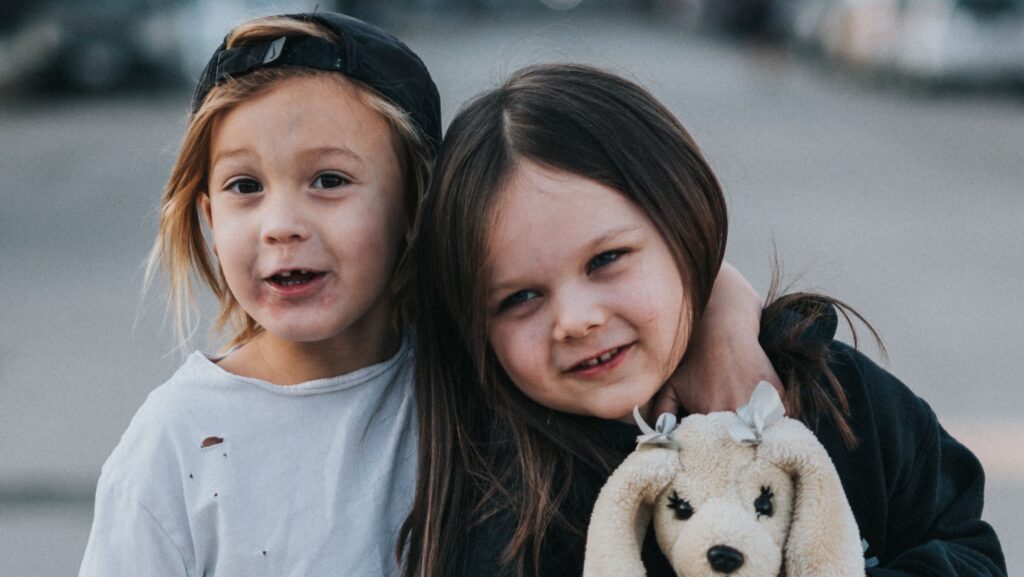 two young kids with stuffed rabbit